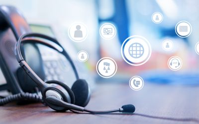 close up focus on call center headset device at VOIP system on telephone machine with virtual interface of communication at office desk for hotline telemarketing and network operation concept