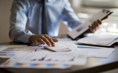 Business accounting concept, Business man using calculator with computer laptop, budget and loan paper in office.