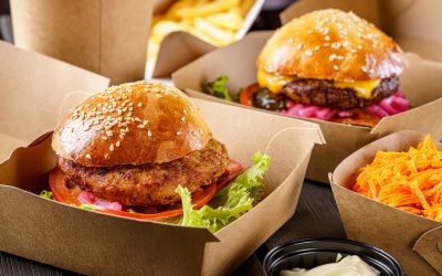 Street food. Meat cutlet burgers are in paper boxes. Food delivery.