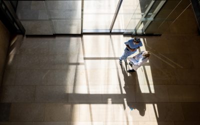 Latin American female doctor talking to a nurse at the entrance hall of a hospital - healthcare and medicine concepts