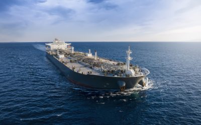 Aerial front view of a heavy loaded crude oil cargo tanker in motion over blue ocean