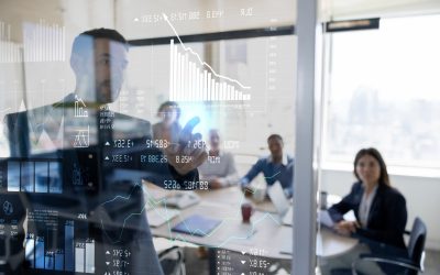Successful Latin American man in a business meeting using an interactive screen while giving a presentation