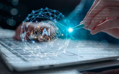 Close-up of hands using laptop and pen with glowing AI interface. Concept of artificial intelligence, data science, machine learning, neural network, and future digital technology integration.