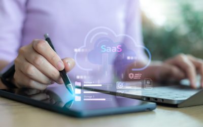 Business person using tablet and laptop with SaaS cloud computing icon for digital data storage, online service, and modern software as a service technology concept.