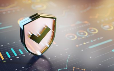 A glossy, three‑dimensional shield with a green checkmark sits above a high‑tech data dashboard, conveying protection, security, and trust in digital systems.