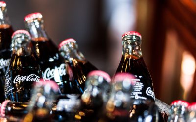 London, UK - January 17, 2015: glass bottles of Coca Cola for sale inside a wooden barrel at Borough Market, London, UK. Borough Market is a wholesale and retail food market in Southwark, Central London, England. It is one of the largest and oldest food markets in London, and sells a large variety of foods from all over the world. Colour image with lots of room for copy space.